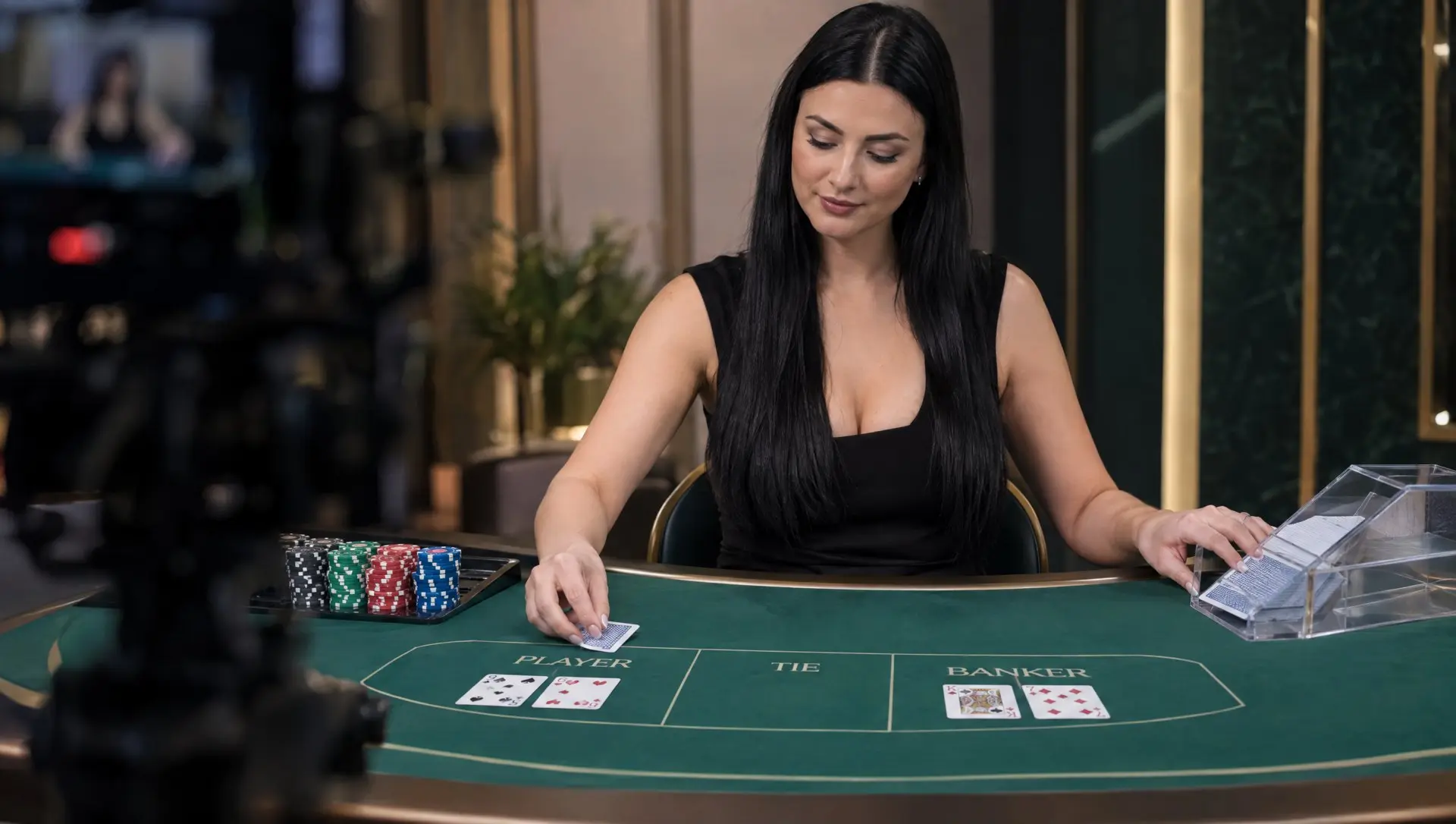 A live casino dealer dealing baccarat cards on a Player, Banker and Tie table