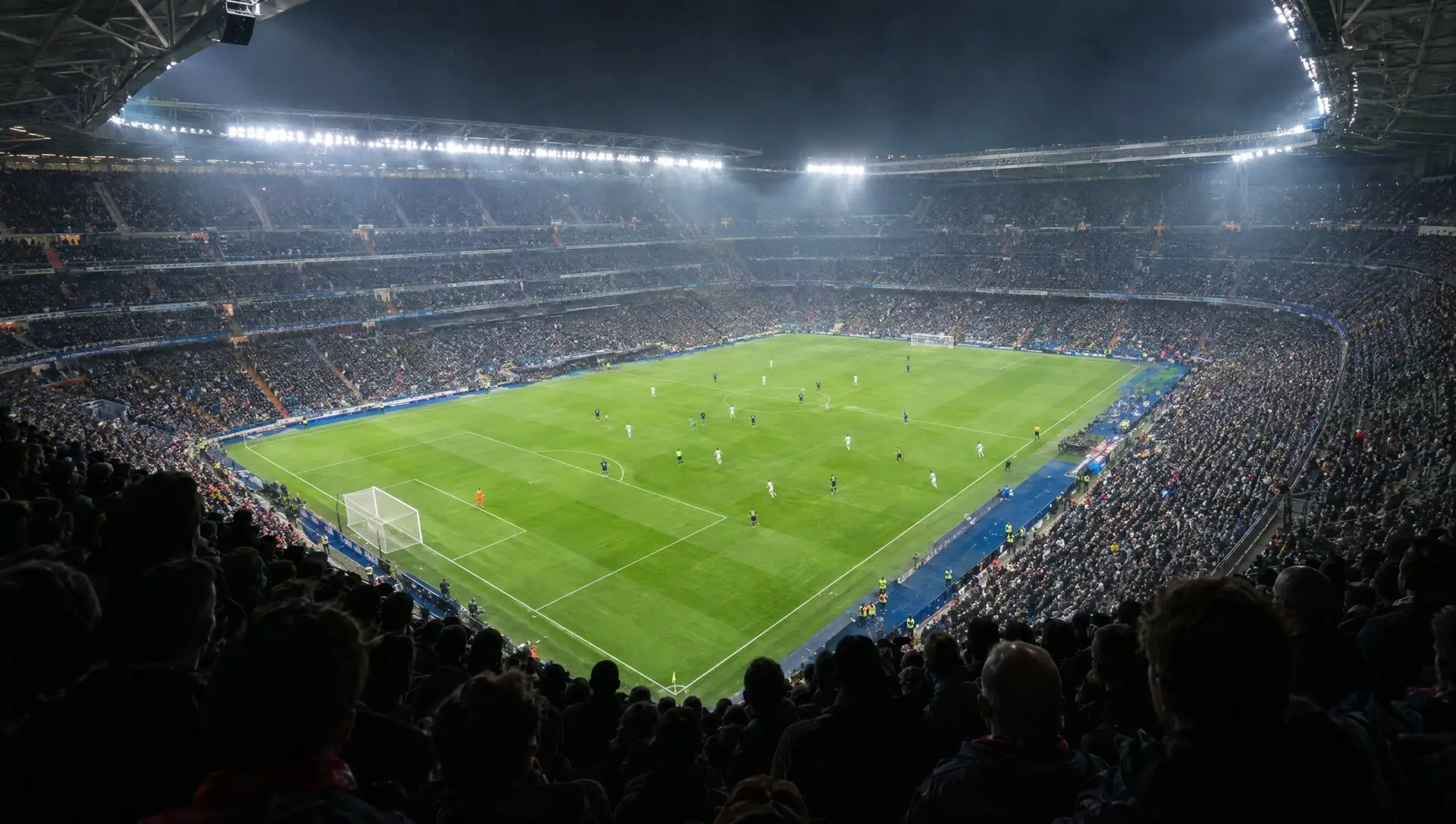 A packed European football stadium under floodlights on a Champions League night